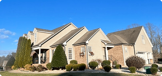 Large beige house with landscaped front yard