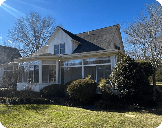 Residential house with large sunroom & white windows